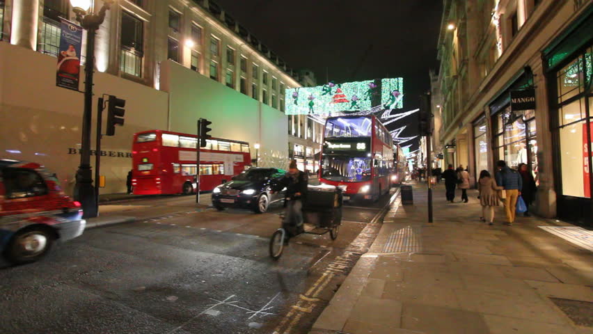 LONDON, UK - DECEMBER 27: Busses and other traffic on Piccadilly with Christmas lights on December 27, 2011 in London, UK. Piccadilly is one of the main shopping streets of London.