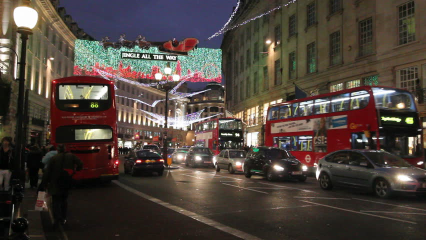 LONDON, UK - DECEMBER 27: Busses and other traffic drive beneath Christmas lights on Regent Street on December 27, 2011 in London, UK. Regent Street is one of the main shopping streets of London.