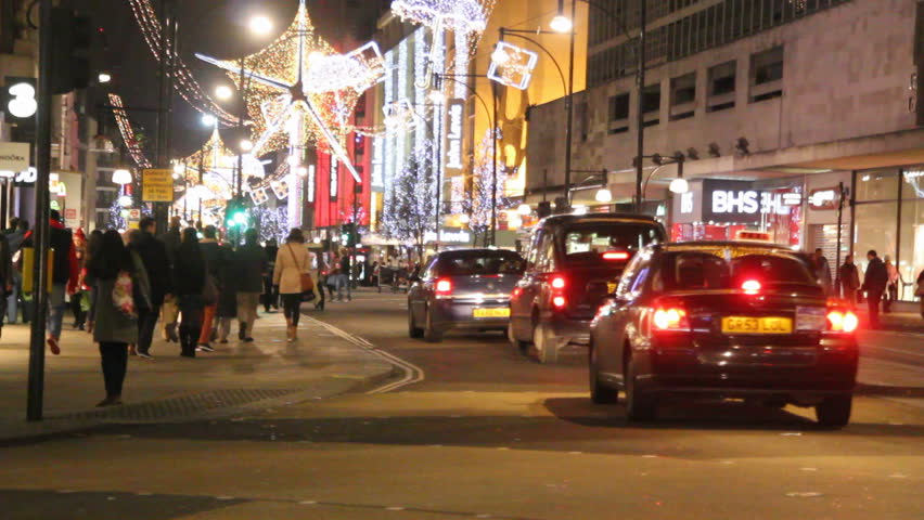 LONDON, UK - DECEMBER 27: Busses and other traffic drive beneath Christmas lights on Oxford Street on December 27, 2011 in London, UK. Oxford Street is one of the main shopping streets of London.
