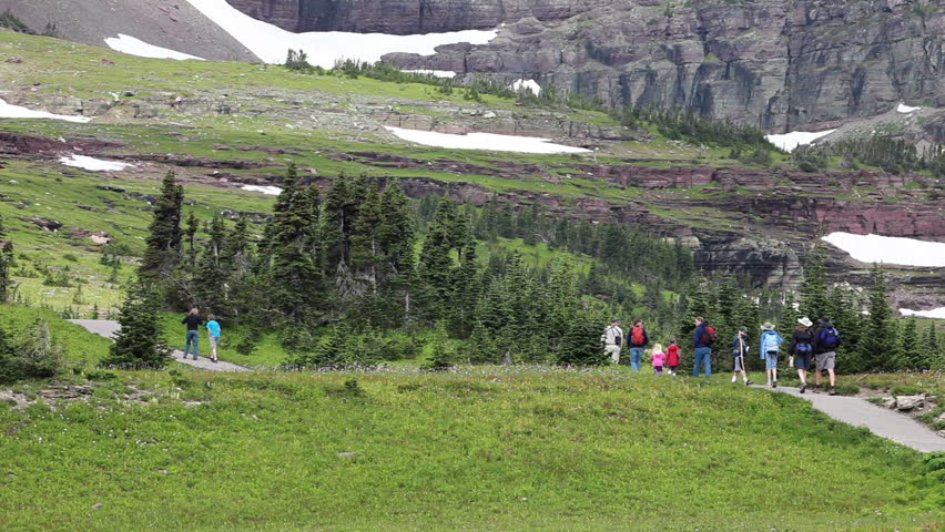 Family and friends mountain trail for exercise explore for wildlife in Montana. Family activities important for growth of happy family. Going to the Sun.