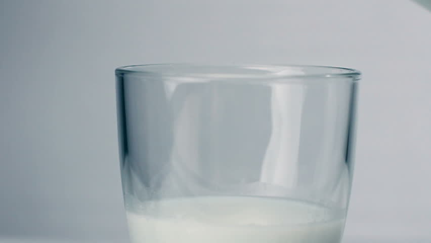 Milk poured into glass in slow motion