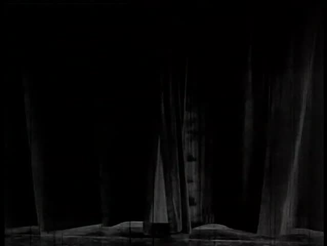 Wide shot of curtain parting to reveal stage and backdrop