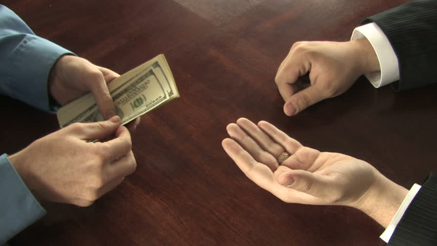 A man pays another man every last bill from a stack of hundreds in his hands 