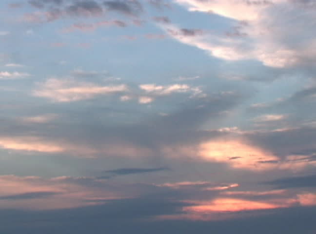 The sunset creates beautiful colors in the clouds.