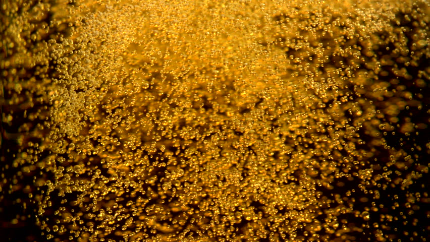 Extreme close-up beer bubbles in glass