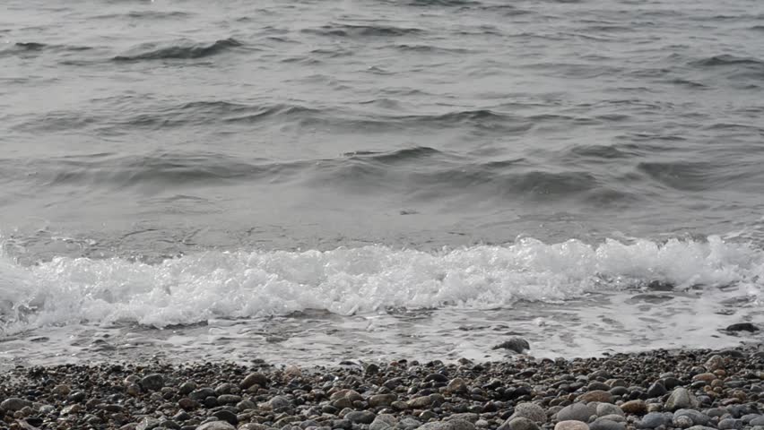 grey and gloomy west coast ocean beach at winter in Vancouver, Canada.