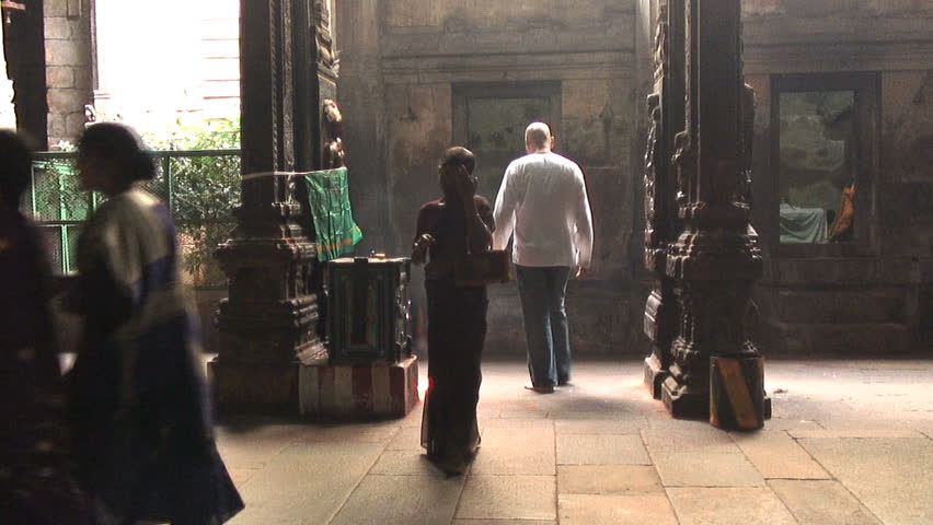 MADURAI, INDIA - NOVEMBER 26, 2006:  Teenage girl prays at Meenakshi Amman Temple in Madurai, India