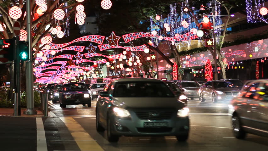 SINGAPORE - NOVEMBER 21: Orchard Road at night. Cars pass below its famous lavish Christmas decoration on November 21, 2009 in Singapore.