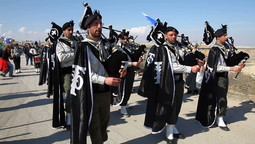 QASR AL YAHUD, ISRAEL - JANUARY 18: Greek Orthodox Palestinian scouts with bagpipes march in Patriarch's procession at Qasr Al Yahud Baptismal Site, Israel on January 18, 2012.