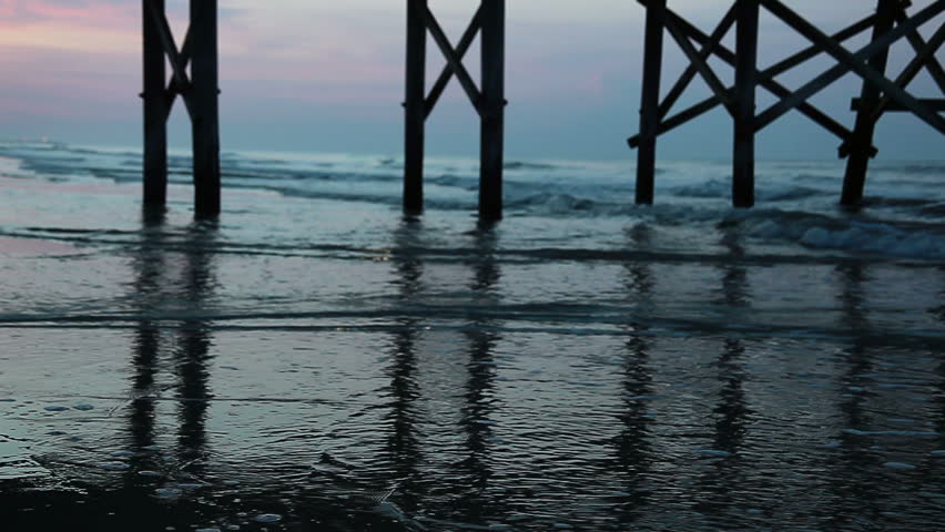 Horizon vista from under beach pier at daybreak - lots of reflections and de-focused background - HD - 1920x1080