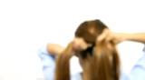 Women is braiding her hair