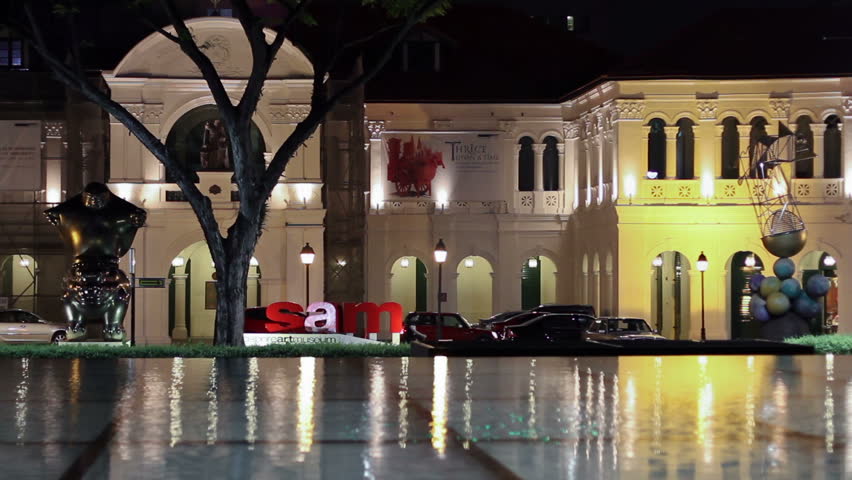 SINGAPORE - NOVEMBER 29: Front facade of the Singapore Art Museum (SAM) at night across a water basin on November 29, 2009 in Singapore. The SAM hosts important exhibitions on local and regional art.