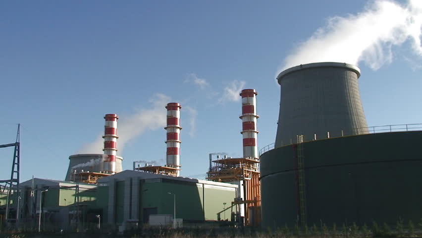 Chimneys of nuclear power plant, cooling towers emitting steam