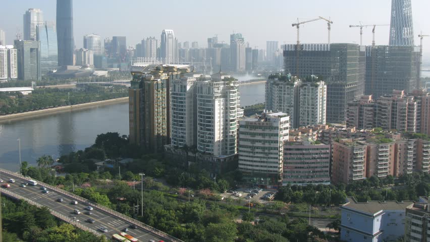 TV Tower and Twin Tower stands on against city landscape in afternoon, time lapse