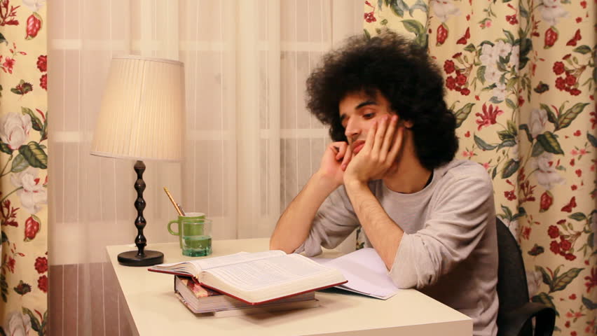 young man getting bored while studying