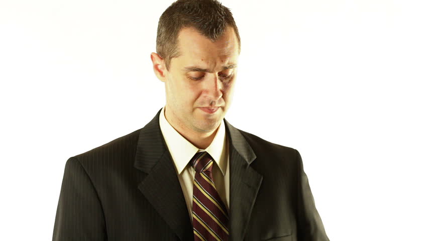 Attractive businessman talking on the phone while shaving