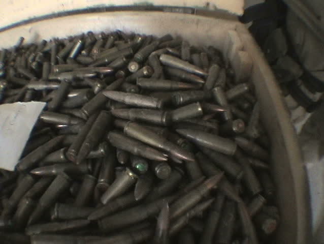 BAGHDAD, IRAQ - CIRCA 5/3/03: U.S. Soldiers discover ammunition cache, small arms, RPG and mortar rounds at Abu Ghraib.