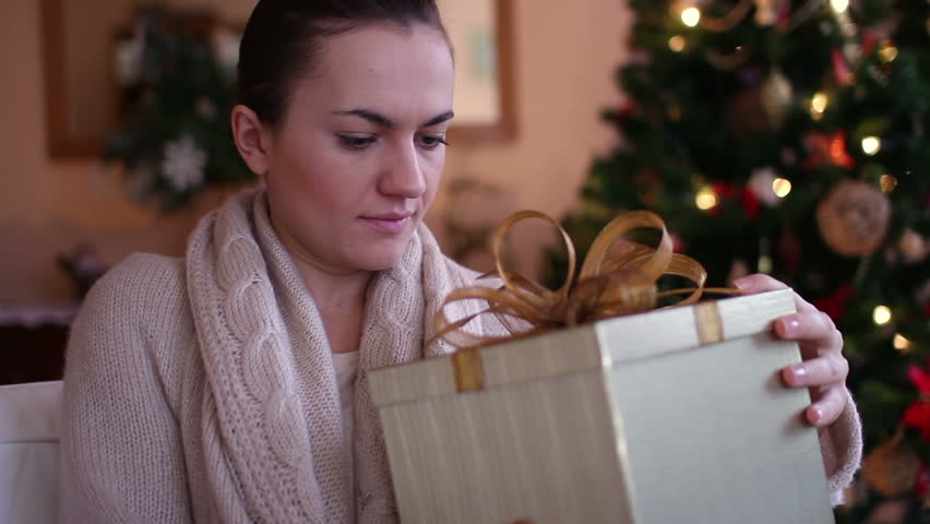 Amazed woman looking at magical christmas gift in the box