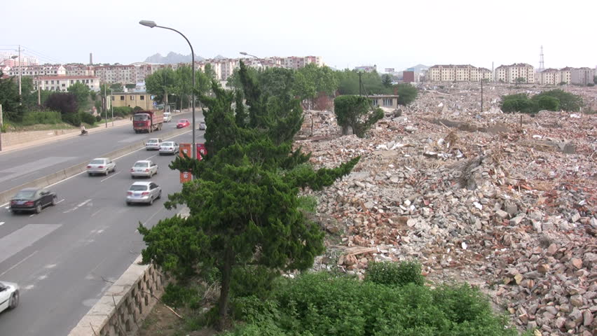 QINGDAO - JUNE 3: Traffic passes a freshly demolished quarter on June 3, 2010 in Qingdao, China.