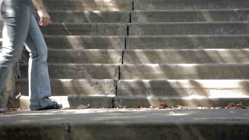 Feet of different people go on a ladder upwards and downwards