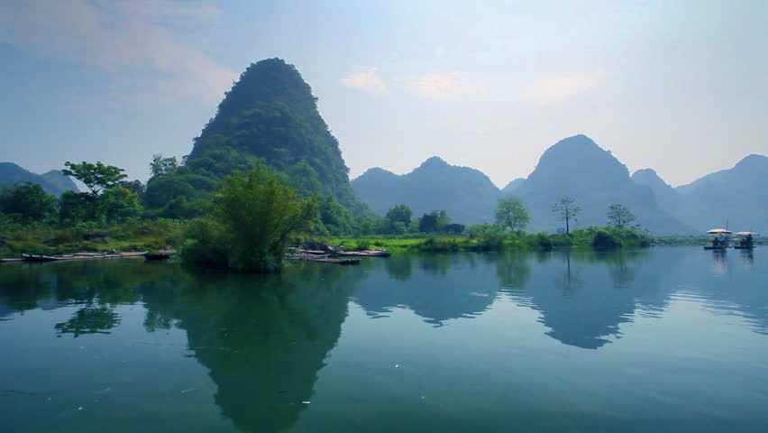 Bamboo raft flowing through the idyllic rural landscape of Yangshuo
