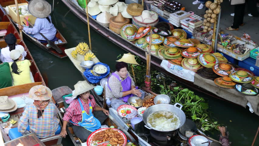 DAMNOEN SADUAK, THAILAND - FEBRUARY 25: Vendors are selling food products in Damnoen Saduak Floating Market, the most famous market near Bangkok on February 25, 2012 in Damnoen Saduak, Thailand.
