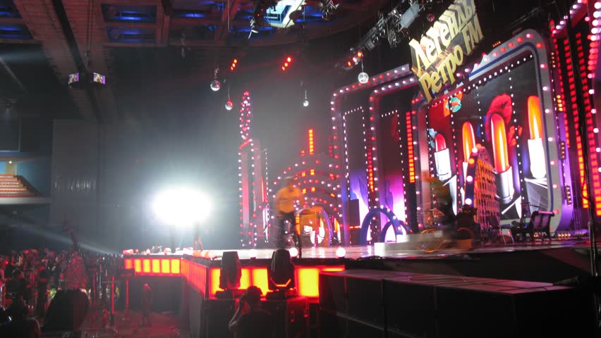 MOSCOW - DEC 17: (Timelapse View) On scene appear duet of artists and go guys by bicycles, concert of Legend RetroFM in Sports complex Olimpiyskiy, on Dec 17, 2011 in Moscow, Russia 