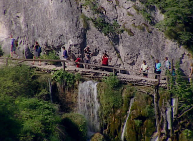 Tourist on a footpath walking and looking to the waterfalls and lakes in National park Plitvicka jezera circa July 2000 in Plitvice Lakes. 