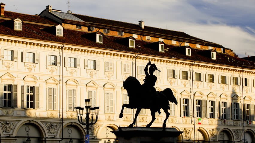 Turin, Italy - February 20, 2012: equestrian statue in San Carlo square, Turin city center, sunset taken with the technique of time-lapse