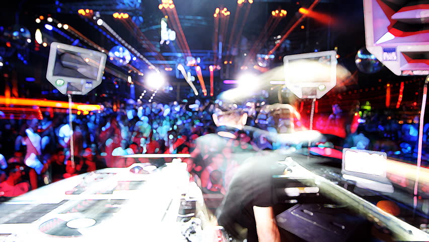 shot of dj playing from behind looking out to the crowd in privilege club, ibiza, spain