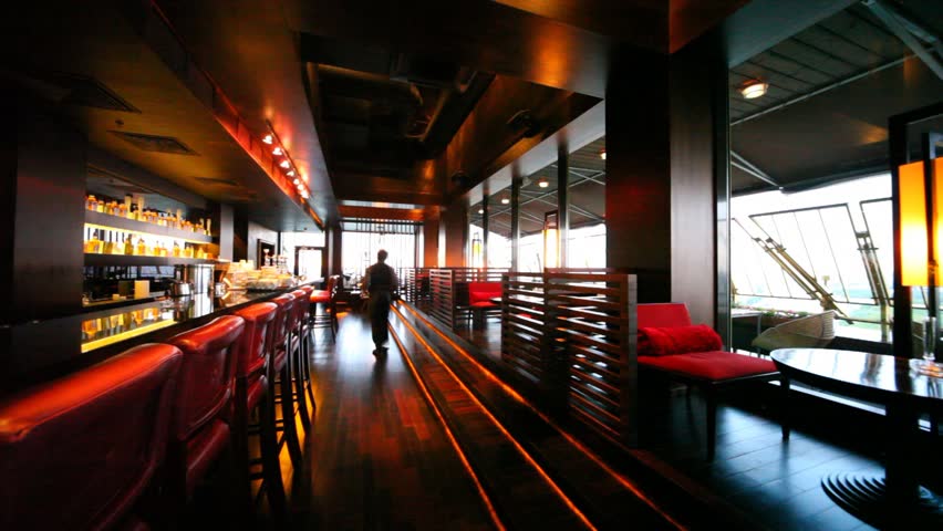 Restaurant lounge is decorated in red-brown tones and yellow lamps