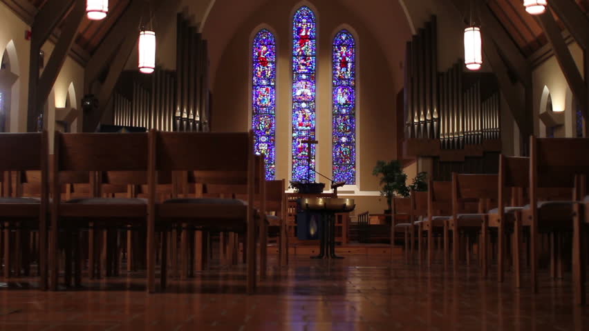 Woman entering church and sitting in pew