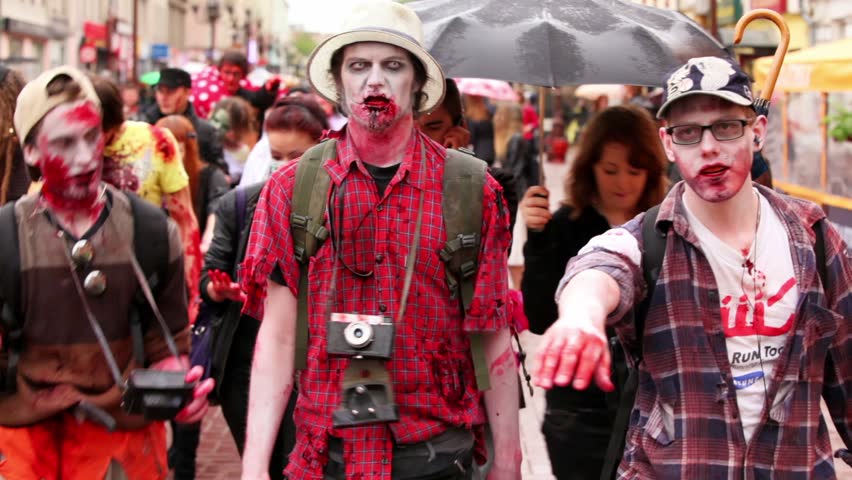 MOSCOW - MAY 14: Bloody zombies walk among people on street at summer day on May 13, 2011 in Moscow, Russia.