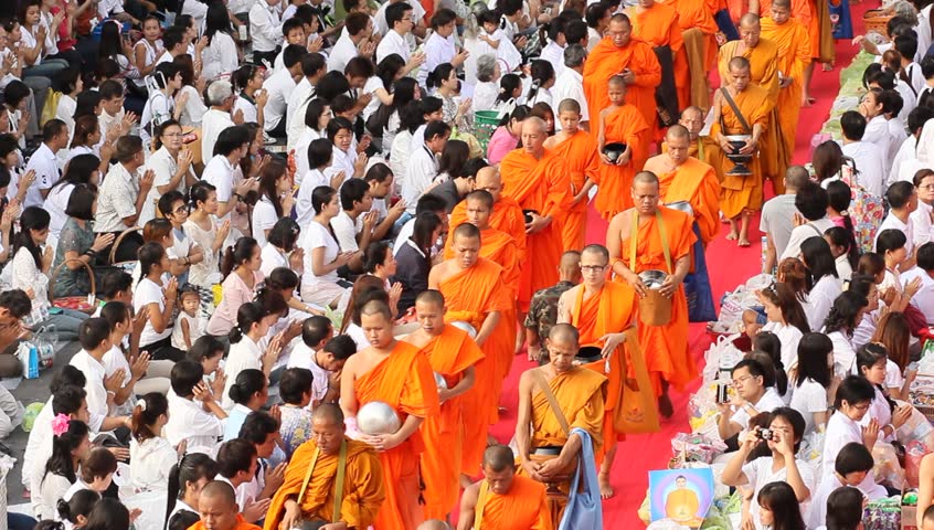 BANGKOK , THAILAND - MARCH 17: People give food offerings to Buddhist monks on March 17, 2012 in Bangkok, Thailand.