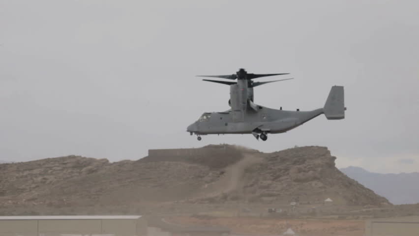 Aircraft V-22 Osprey VTOL hover flying backwards doing vertical takeoff and landing over flight line video in Utah. USAF, Marines, Navy and NATO in Iraq and Afghanistan.