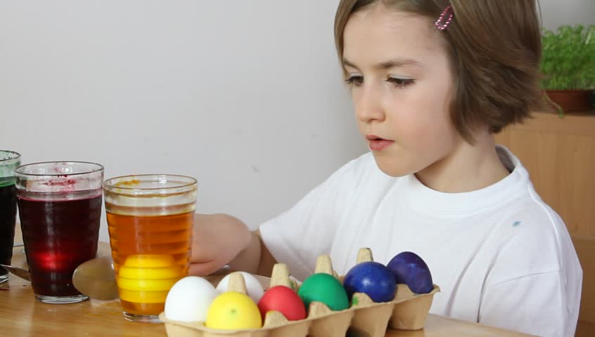 Little girl coloring Easter eggs (HD version)