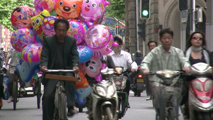 SHANGHAI - JUNE 1: People are going to work on motorbikes and bicycles in Shanghai, China  on June 1, 2010. 
