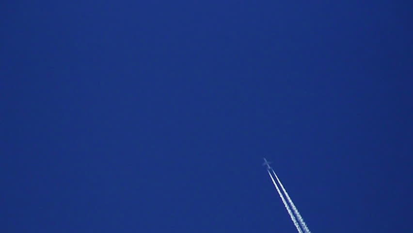 Airplane vapour trails across clear blue sky 3