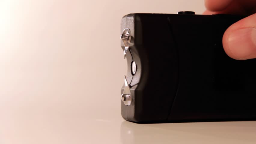 A man presses a taser self defense weapon