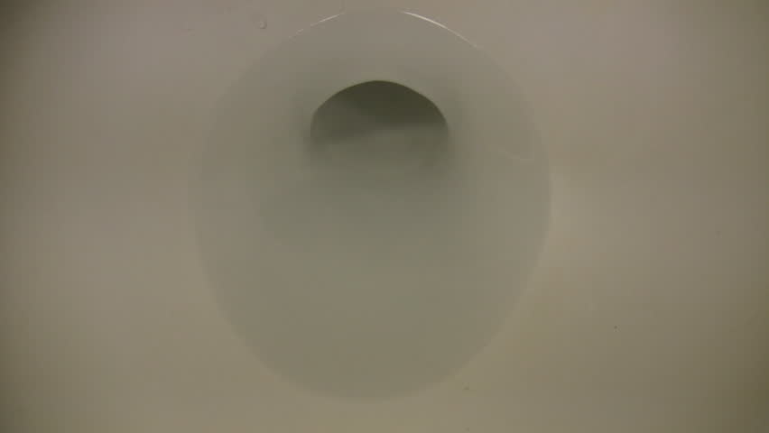 A closeup view of a flushing toilet. Don't worry, the toilet is only flushing clean water. (High Definition)