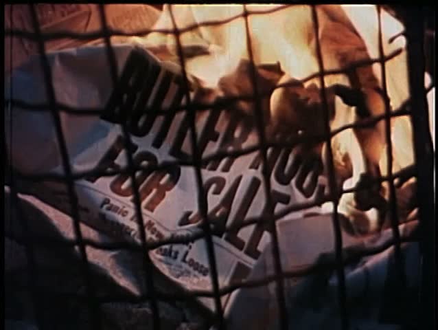 Close-up of newspaper on fire in garbage can