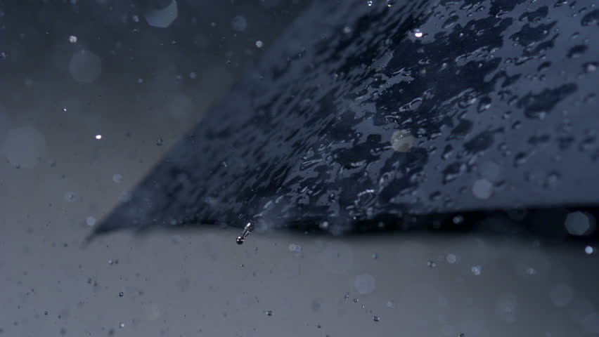 Slo-mo rain hitting umbrella