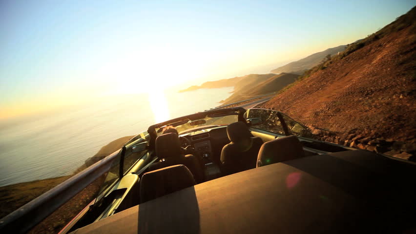 Time lapse of a driving Cabriolet on a winding coastal highway