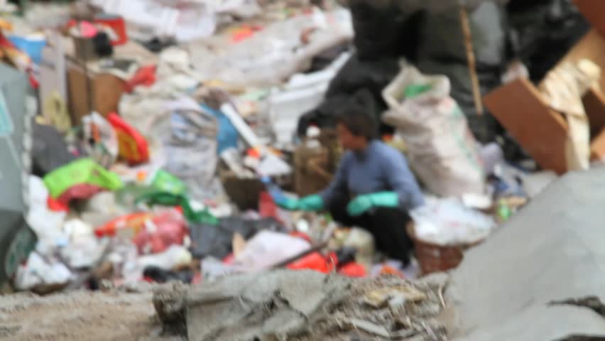 HONG KONG -  CIRCA 2011: Homeless woman drinking water out of the trash circa 2011 in Hong Kong. 