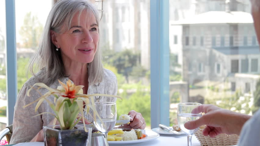 Senior couple enjoying a glass of wine and lunch overlooking the Blue Mosque, Istanbul, Turkey