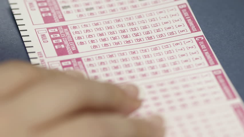 Lottery Ticket Filling Spanish (HD). Spanish Language generic lottery ticket being filled by a woman. 