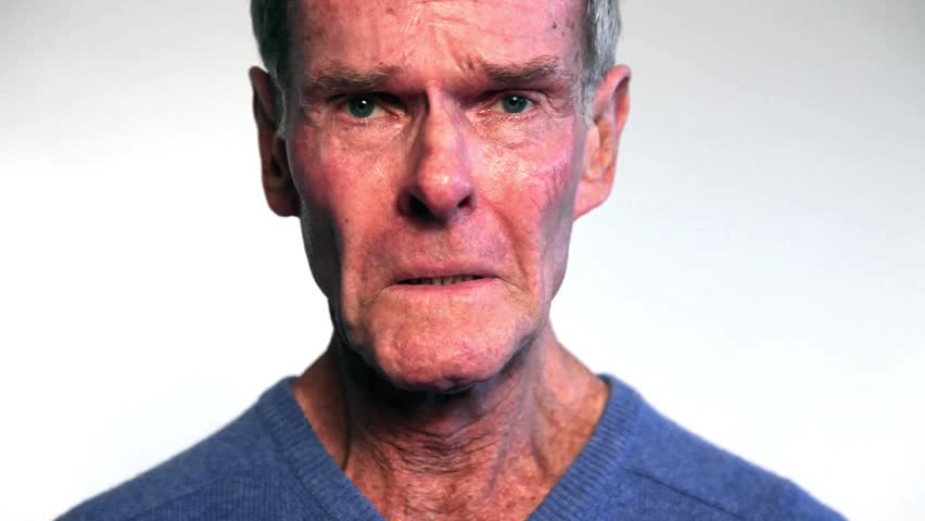 Sad senior man isolated on white background. Crying. Close up studio portrait.