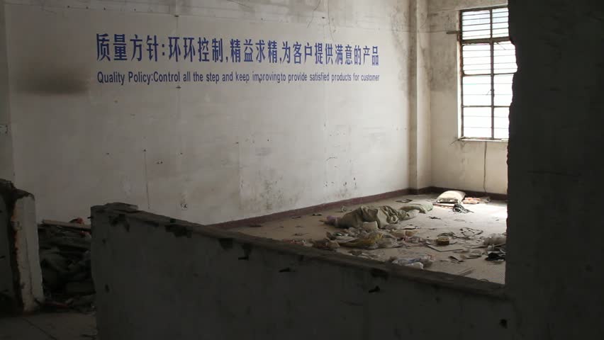 Quality control sign in a room filled with trash, scum, and grime