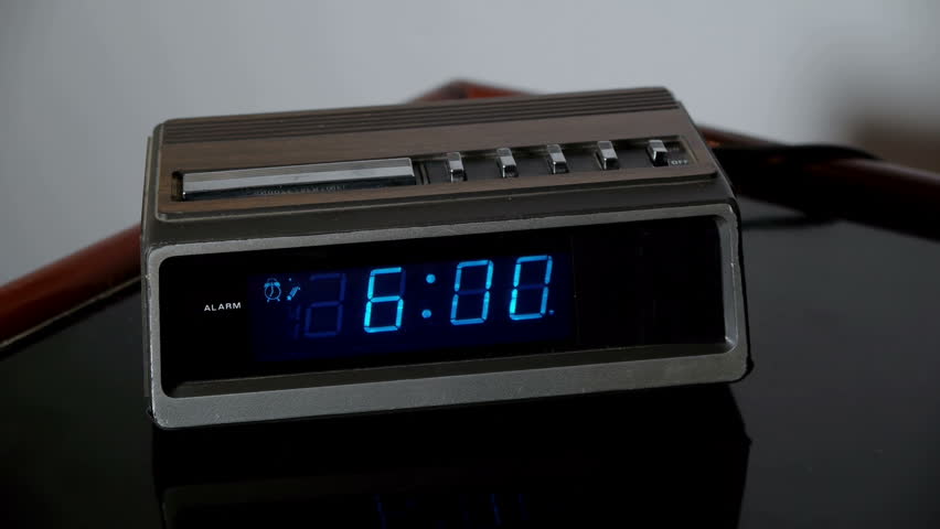 Alarm Clock Wake Up Snooze (HD). Digital alarm clock from the 70s rings and is hastily snoozed by a male hand angry for being woken up at 6am.