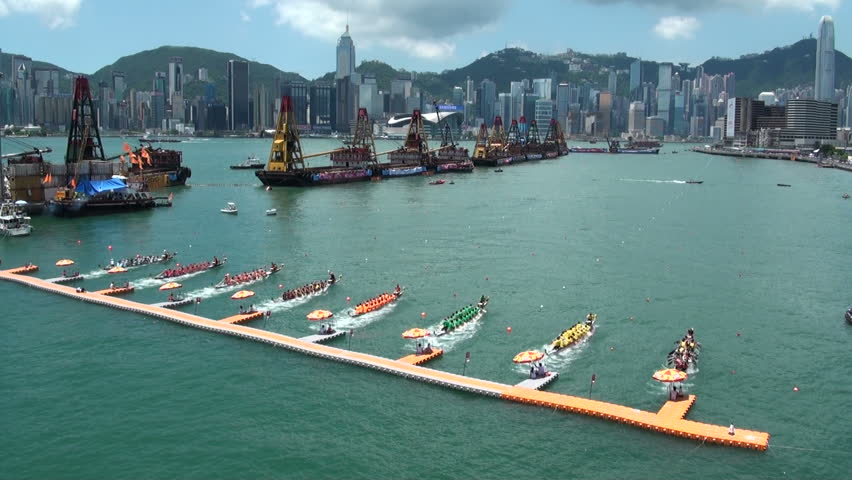 People take part in a traditional dragon boat race, with the skyline of Hong Kong in the background, in Hong Kong, China